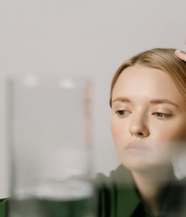 Woman with a serene expression, looking calmly into the distance, symbolizing mental clarity.
